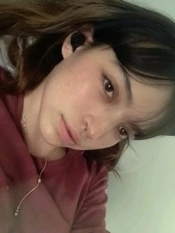 Woman with a fringe and freckles, close up