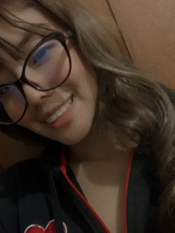Woman in glasses smiling, close up